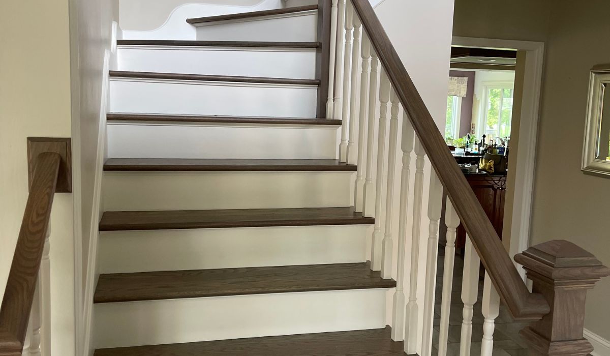 wooden stair with brown treads and handrails and white risers and spindles