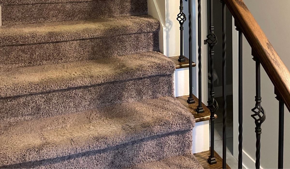 brown carpet runner on the staircase